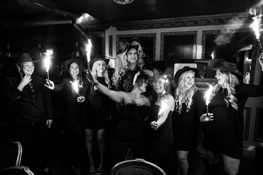 Group of girls with sparklers at a brunch at Mu Mus