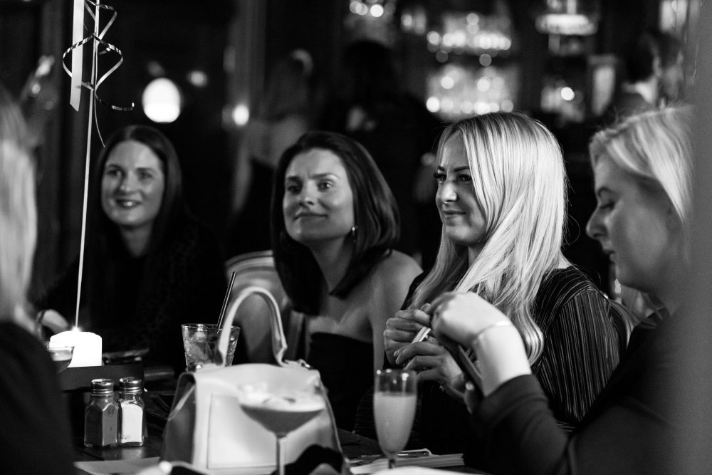 Blonde girl listening to the entertainment at bottomless brunch